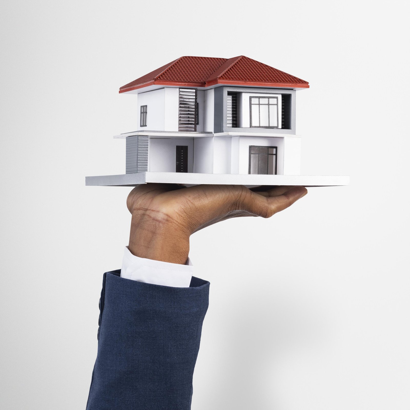 hand-holding-house-real-estate-property-model